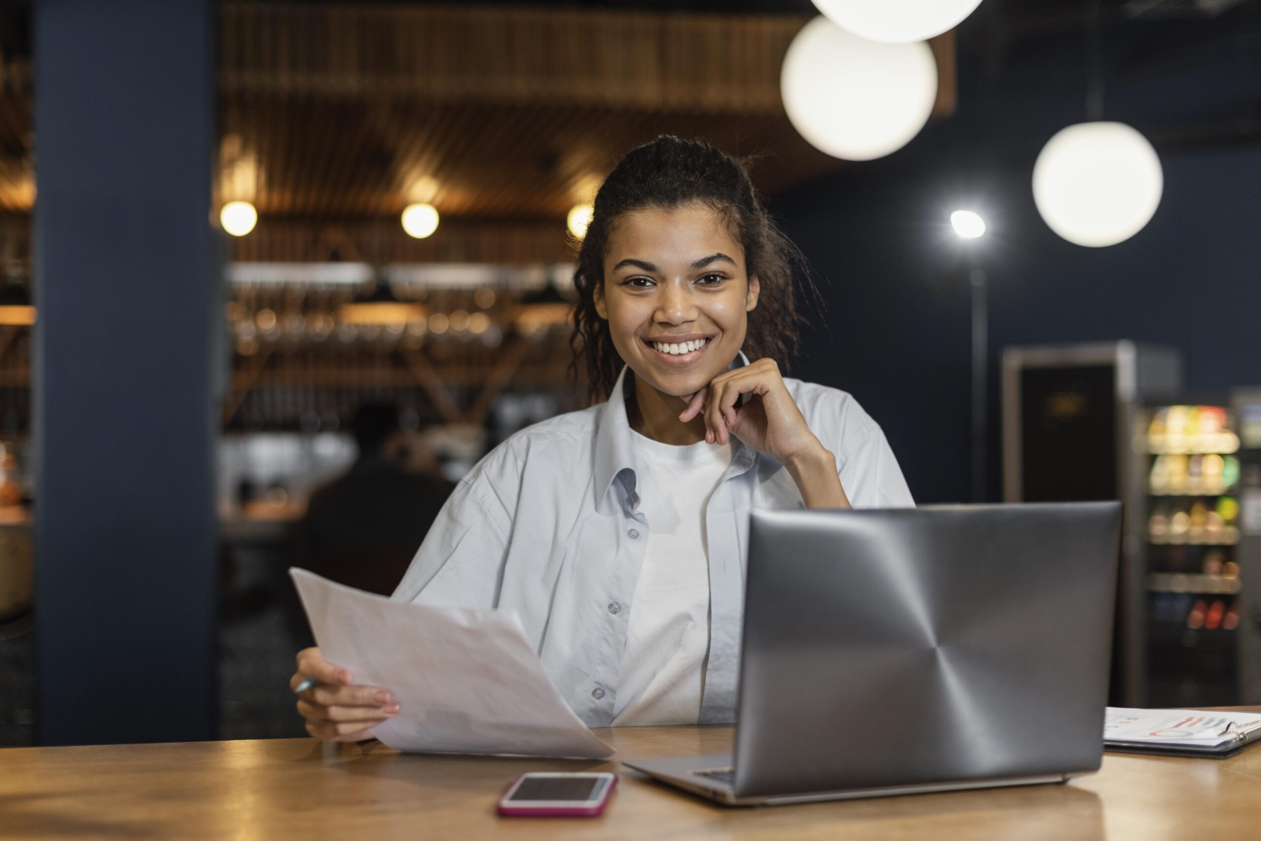 front-view-smiley-woman-working-office-front-laptop